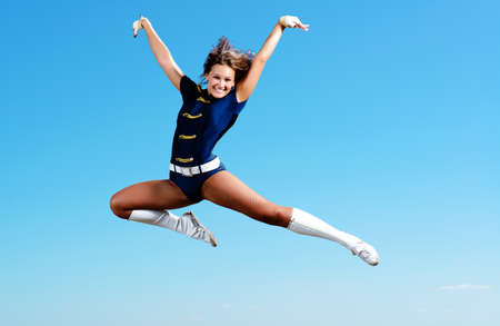 dancer jumping on a background of blue skyの写真素材