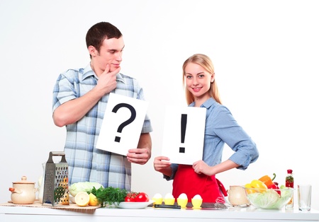 couple holding a plate with signs question and exclamationの写真素材