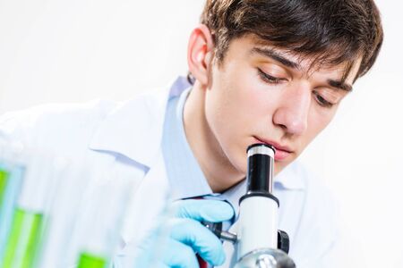 milled scientist looking into a microscope, a close-up