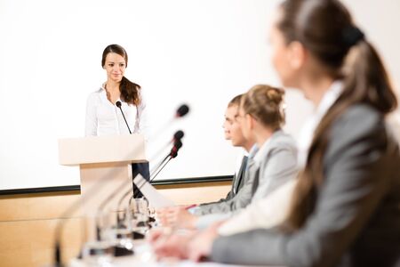 Business woman speaks into a microphone, communication businessmen at a conferenceの写真素材