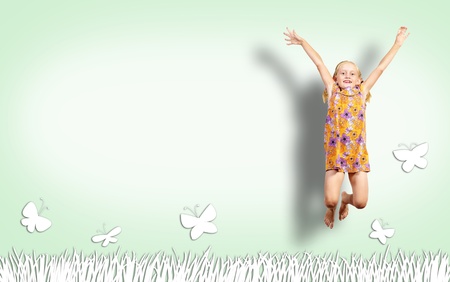 Girl jumping in a color dress on paint wall  collage of a happy childhoodの写真素材