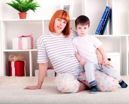 portrait of a pregnant woman and her son, at homeの写真素材