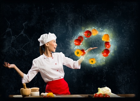 Asian woman chef juggling with vegetables in one hand, a collageの写真素材