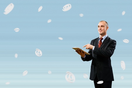 business man holding a tablet, fly around the signs e-mailの写真素材