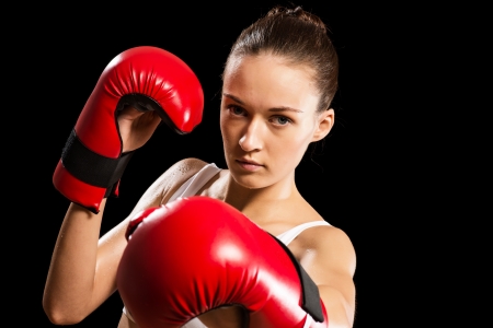 portrait of a woman boxer, aggressive and looks at the camera, close-upの写真素材