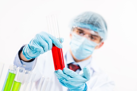 scientist working in the lab examines a test tube with liquidの写真素材