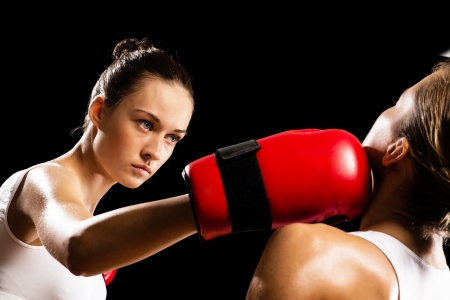 Aggressive boxing woman, hits an opponent in the headの写真素材