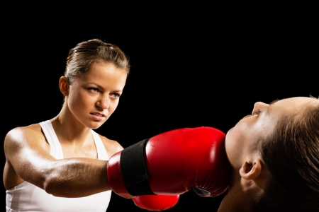 Aggressive boxing woman, hits an opponent in the headの写真素材