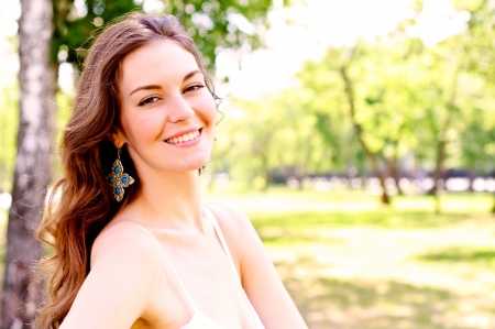 Portrait of an attractive woman in the park, smile and happyの写真素材
