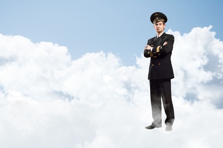 pilot is in the form of arms folded, against the sky with clouds