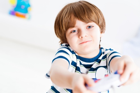 Boy playing on a game console, have fun