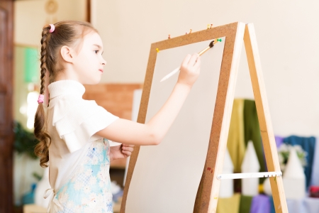 portrait of a girl standing next to his easel, a drawing lessonの写真素材