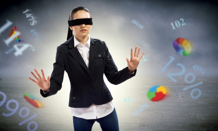 young blindfolded woman  can not find a way of flying charts and numbersの写真素材