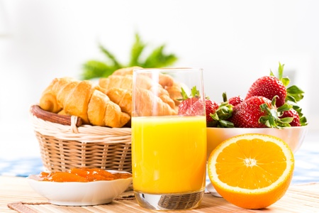 early breakfast, juice, croissants and jamの写真素材