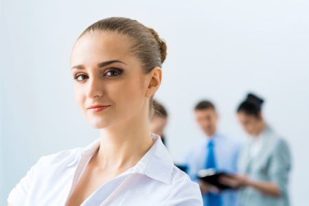 successful business woman in the office  against colleaguesの写真素材