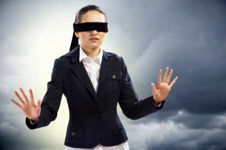 young blindfolded woman  can not find a way outの写真素材