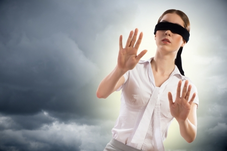 young blindfolded woman  can not find a way outの写真素材