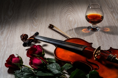 Violin, rose, glass of champagne and music books, still lifeの写真素材