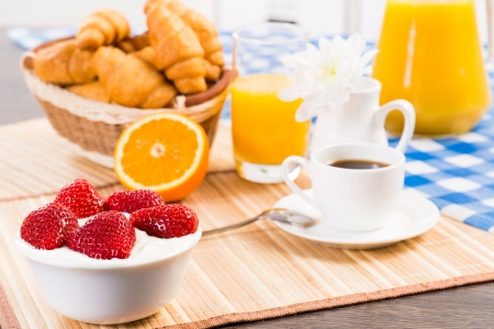 continental breakfast  coffee, strawberry with cream, croissantの写真素材