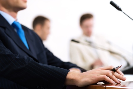 close-up a hand holding a microphone, chat at the conferenceの写真素材
