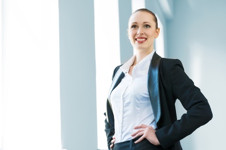 young modern business woman in a bright office smiling