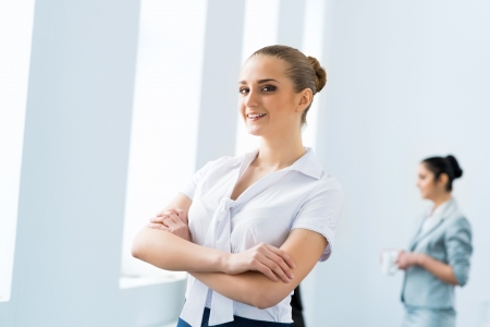 successful business woman in the office  against colleaguesの写真素材