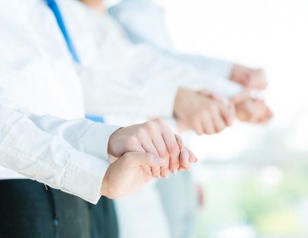 hands of businessmen, businessmen hold hands, stand in a row, the concept of teamwork