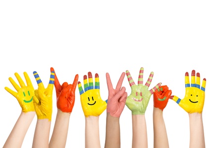 painted children s hands in different colors with smiliesの写真素材