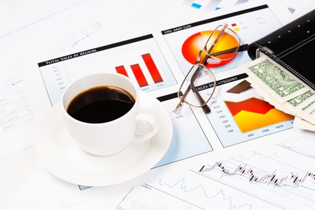 diary, glasses, a cup of coffee and business documents with charts, business still lifeの写真素材
