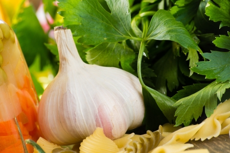 Close-up of garlic and basil leaves, pasta aroundの写真素材