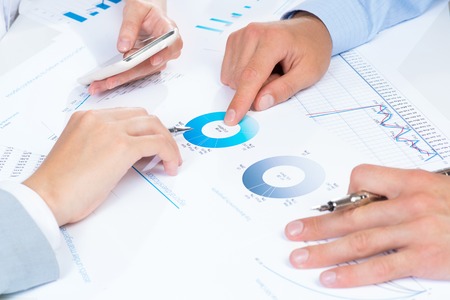 business people discuss meeting targets, sitting at the business table with documents