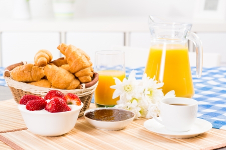 continental breakfast  coffee, strawberry, croissant and juiceの写真素材