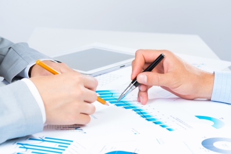 business people discuss meeting targets, sitting at the business table with documentsの写真素材
