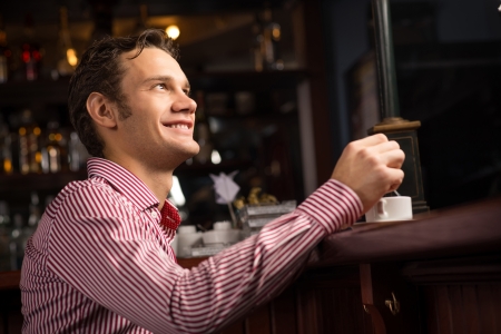 man with a cup of coffee at the barの写真素材
