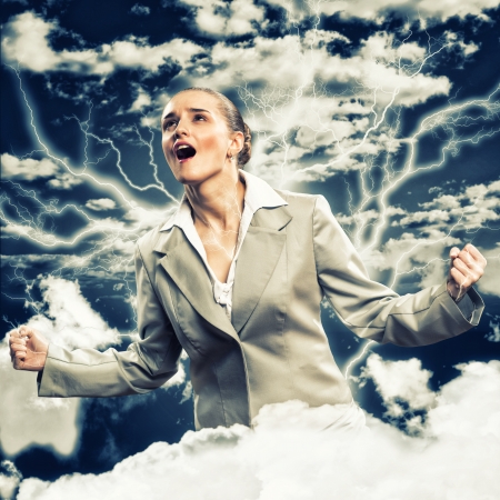 furious woman is straining arms and looking up, concept violent personの写真素材