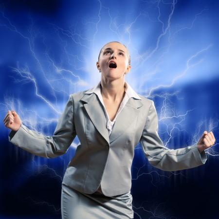 furious woman is straining arms and looking up, concept violent personの写真素材