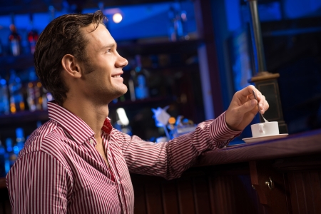 man with a cup of coffee at the barの写真素材
