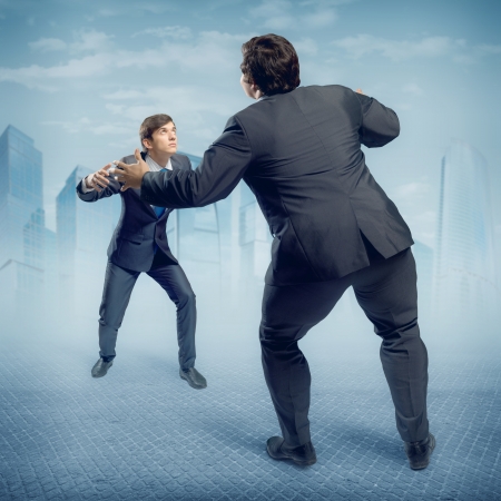 two businessmen fighting as sumoists, the concept of competition in businessの写真素材