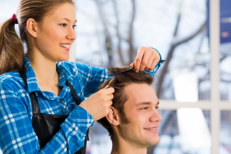 young attractive woman hairdresser hairstyle customer picksの写真素材