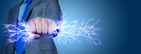 close-up of clasped hand, hand of lightning flashes and lightsの写真素材