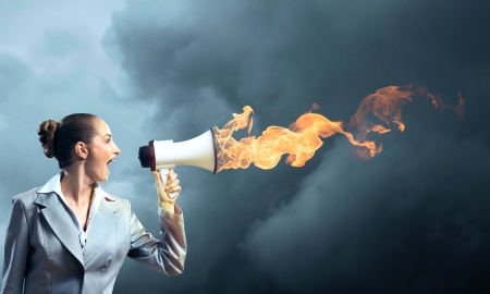 business woman cooks shouting into a megaphone, megaphone fireの写真素材