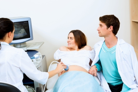 pregnant woman and the future father of the doctor s office, ultrasound diagnosticsの写真素材