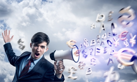 businessman shouting into a megaphone, the concept of aggression in businessの写真素材