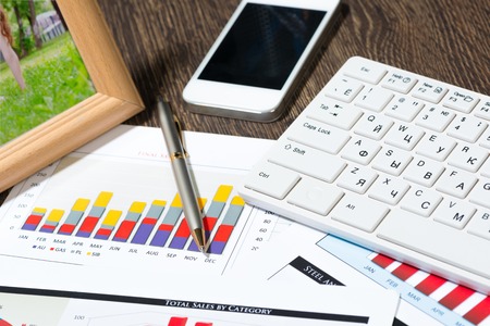 business documents with charts growth, keyboard and pen  workplace businessman