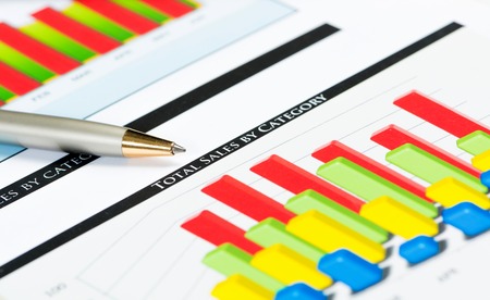 close-up of pen and financial growth charts, workplace businessmanの写真素材