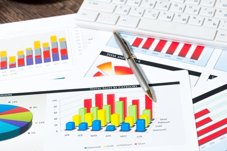 business documents with charts growth, keyboard and pen  workplace businessmanの写真素材