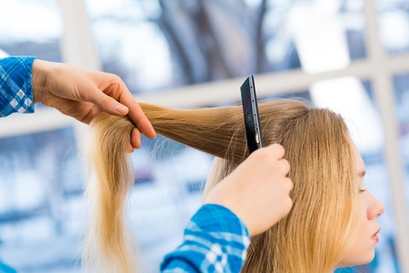 close up combing hair at the hairdresserの写真素材