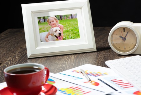 photo frame, business papers with financial charts