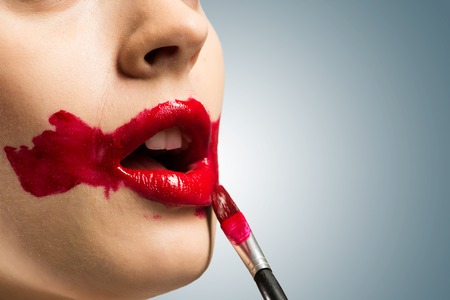 close-up of a female vivid red mouth, lipstick red paintの写真素材