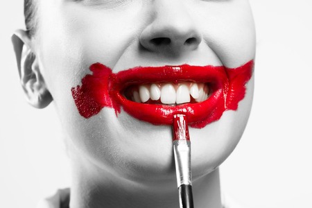 close-up of a female vivid red mouth, conceptual black and white imageの写真素材